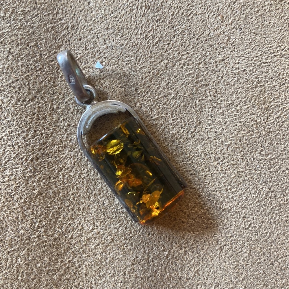 Silver pendant with green amber stone